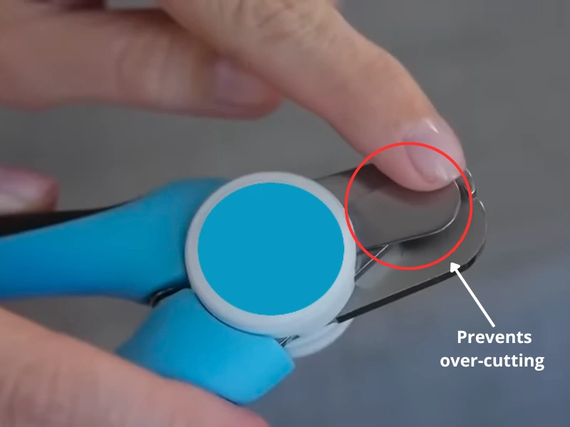 Close-up of safety guard feature on clipper with annotation showing how it prevents over-cutting